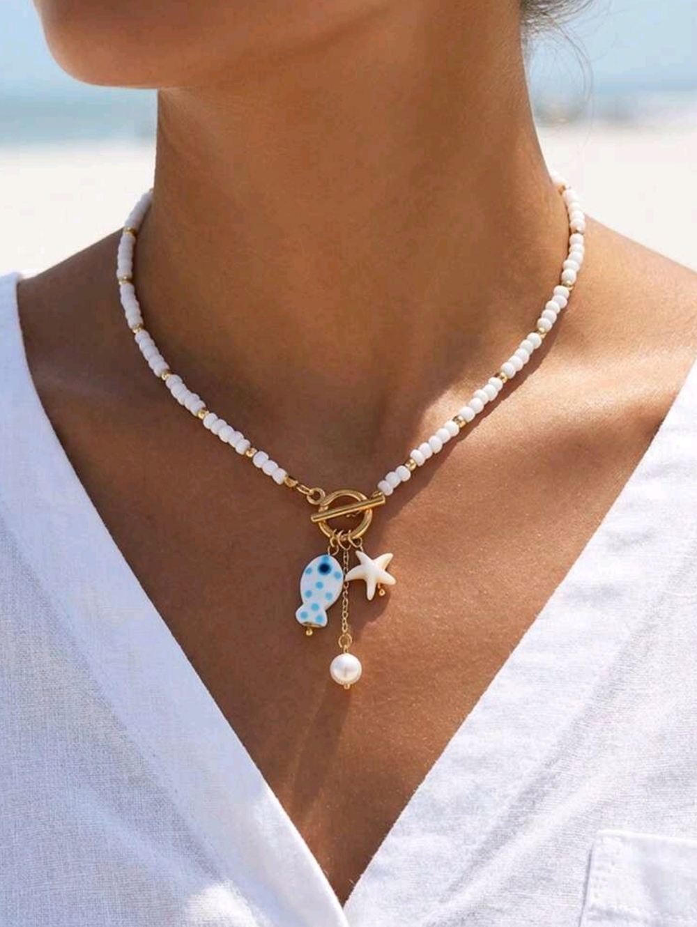 Ceramic starfish, fish and pearl charm necklace; 18.19" around neck; nwot